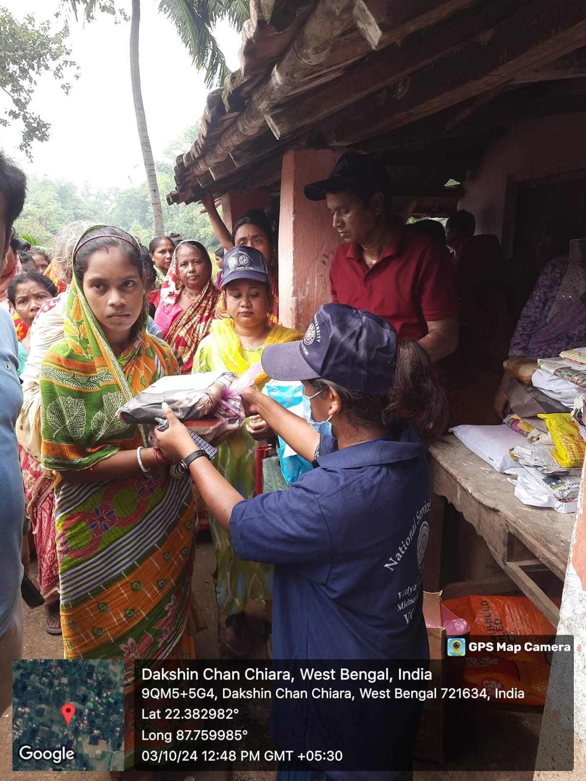 NSS volunteers distributing relief packets at Dakhin Chachiara village